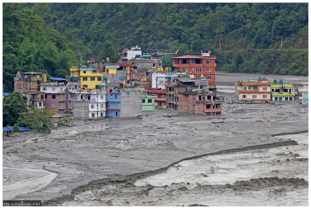 Devastating floodwaters and debris surrounding homes in Nepal’s Himalayan border region